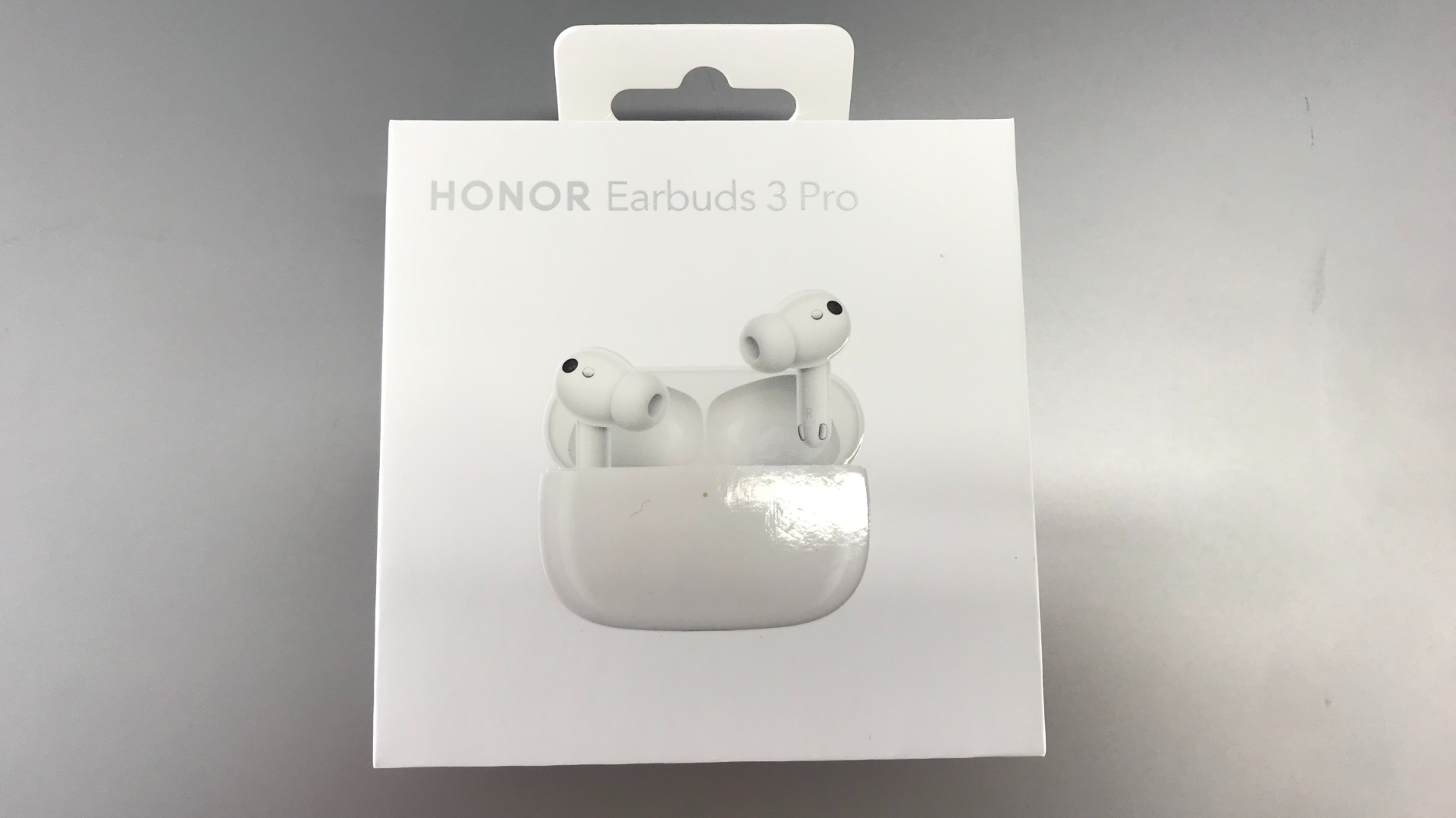 Honor Earbuds 3 Pro packaging on silver background