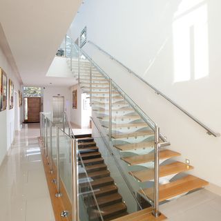 staircase with white wall and tiles flooring