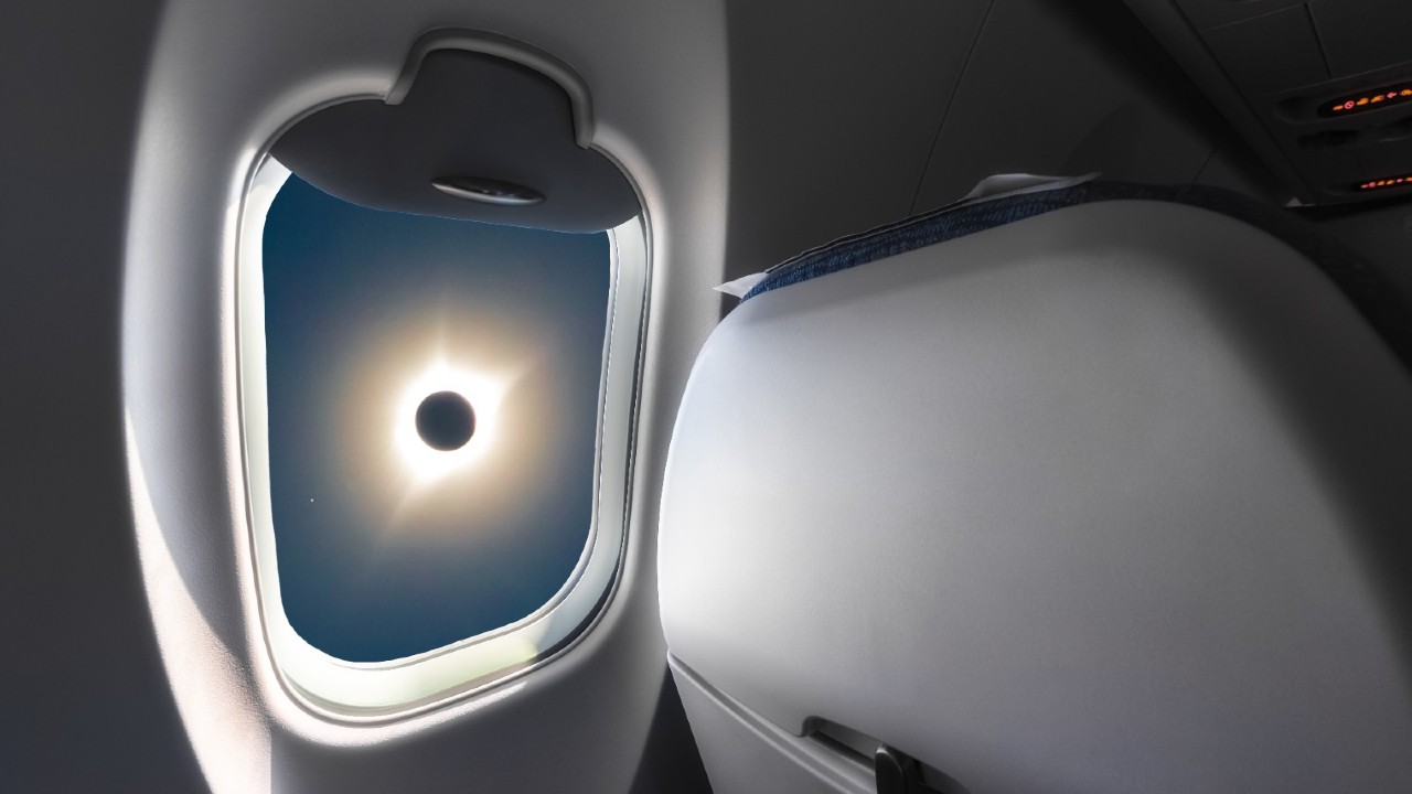 a total solar eclipse seen through an airline window