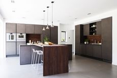 modern handleless dark kitchen with wooden breakfast bar