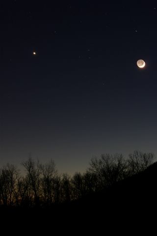 The crescent moon and Venus shine bright over the Housatonic River in Kent, Conn., on Dec. 26, 2011 during a dazzling conjunction. This photo was taken by skywatcher Scott Tully.skywatcher