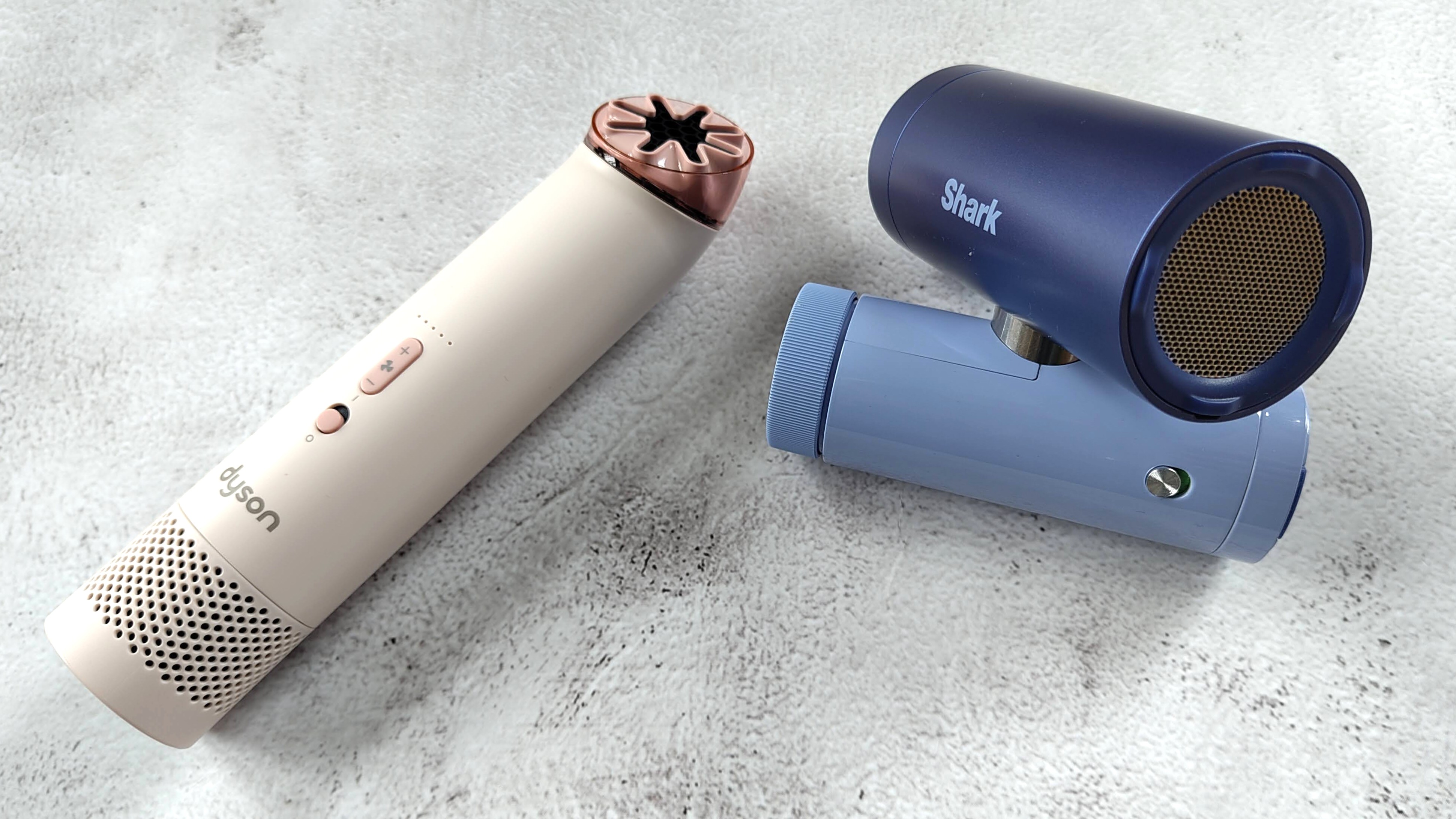 Dyson HushJet Mini Cool Fan and Shark ChillPill fans on marble-effect table