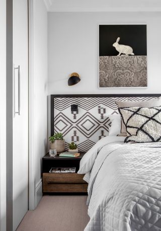 Black and white bedroom with patterned headboard