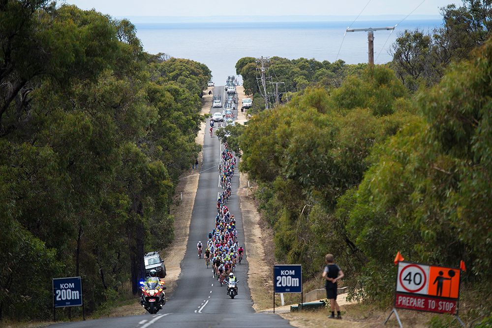 The peloton string out on the wide roads