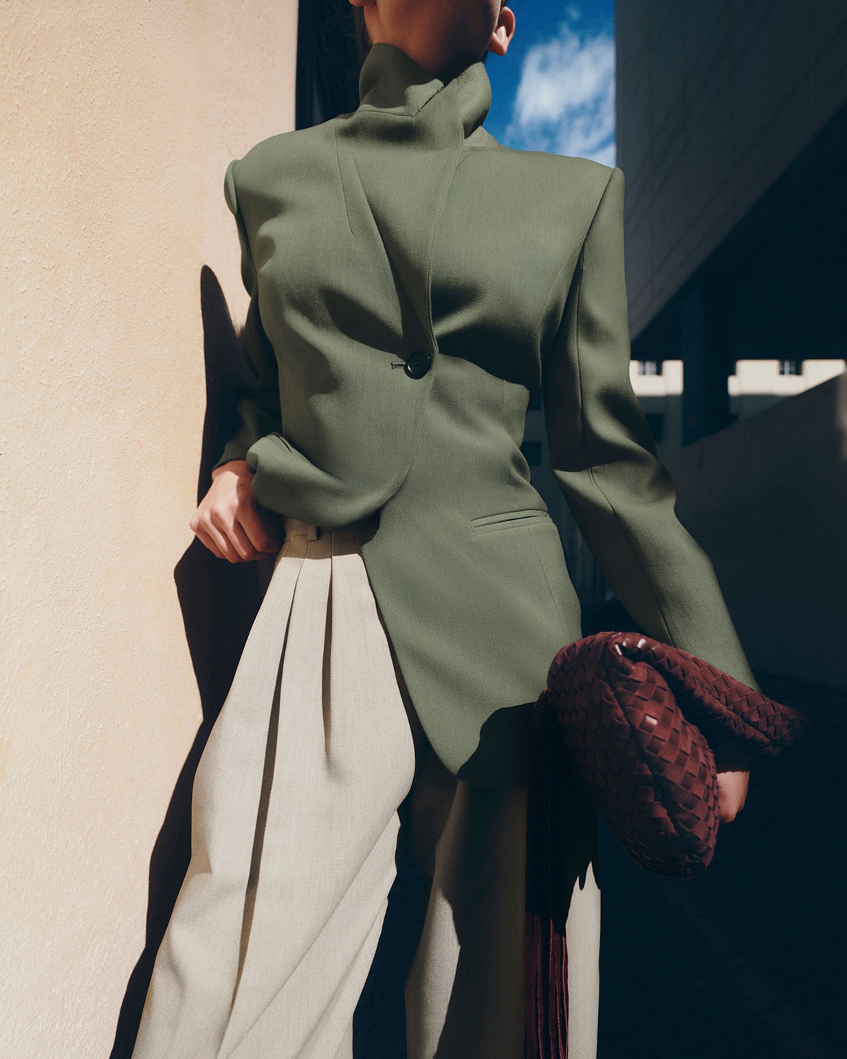 Woman wearing a green jacket and beige trousers in Marks and Spencer campaign