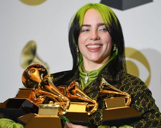 Billie Eilish poses in the press room with the awards for Album Of The Year, Record Of The Year, Best New Artist, Song Of The Year and Best Pop Vocal Album during the 62nd Annual Grammy Awards