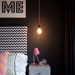 bedroom with black wall and bulb