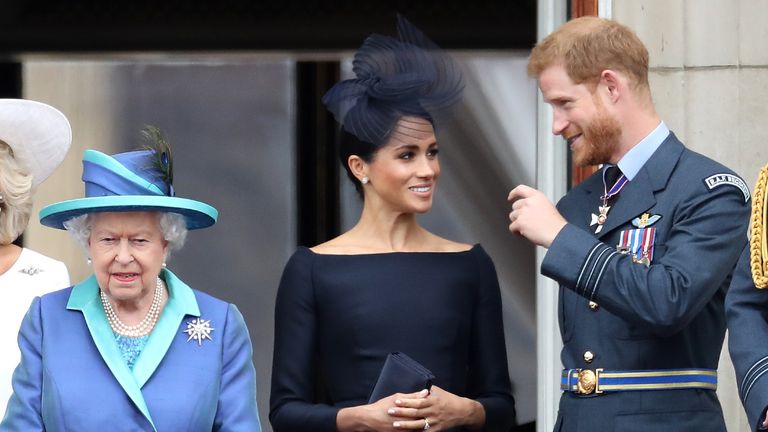 Queen Elizabeth II, Prince Harry, Duke of Sussex and Meghan, Duchess of Sussex on the balcony of Buckingham Palace as the Royal family attend events to mark the Centenary of the RAF on July 10, 2018 in London, England.