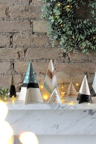Christmas crafts, wooden trees which have been painted in Nordic colours