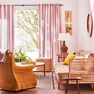living room with wooden sofa and pink curtain