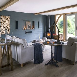 blue living room with sofa set and fire place