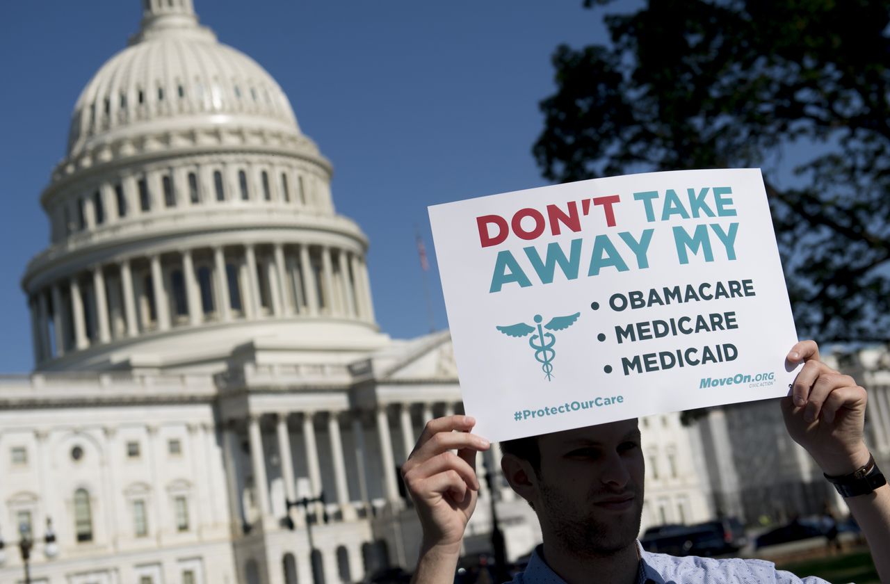 A man protests against the GOP health-care plan.