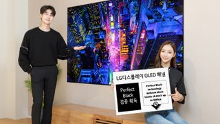 LG OLED TV in bright room with company reps showing perfect black specification sign