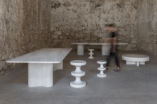 White marble tables and stools, India Mahdavi Achromia show at Carwan gallery