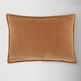 a burnt orange velvet rectangle pillow