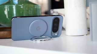 A Google Pixelsnap ring attached to the back of the Google Pixel 10 Pro XL via Qi2 magnets