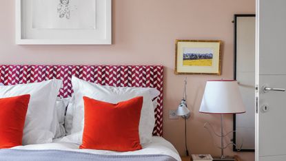 Pink bedroom with red cushions