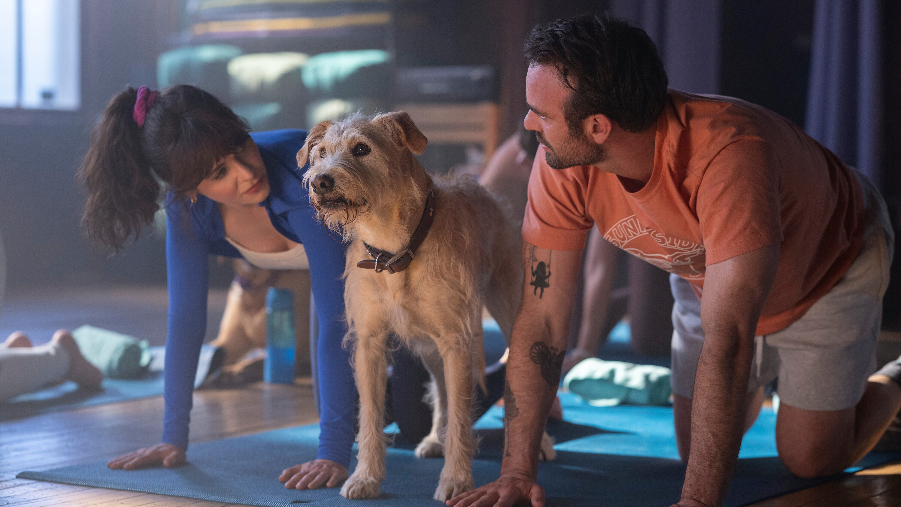 L-R: Anna (Zooey Deschanel), Merv and Russ (Charlie Cox) doing yoga in a scene from Prime Video&#039;s &amp;quot;Merv&amp;quot;