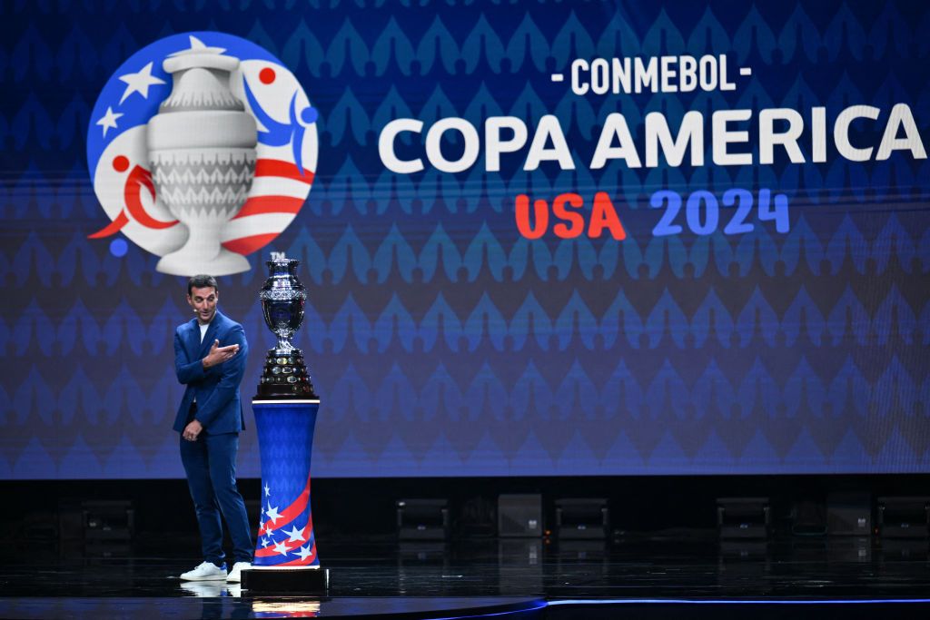 Argentina&#039;s coach Lionel Scaloni presents the Copa America trophy onstage during the final draw for the Conmebol Copa America 2024 football competition at the James L. Knight Centre in Miami, Florida, on December 7, 2023. (Photo by ANGELA WEISS / AFP) (Photo by ANGELA WEISS/AFP via Getty Images)