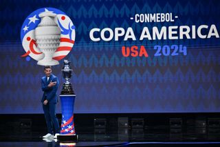 Argentina's coach Lionel Scaloni presents the Copa America trophy onstage during the final draw for the Conmebol Copa America 2024 football competition at the James L. Knight Centre in Miami, Florida, on December 7, 2023. (Photo by ANGELA WEISS / AFP) (Photo by ANGELA WEISS/AFP via Getty Images)