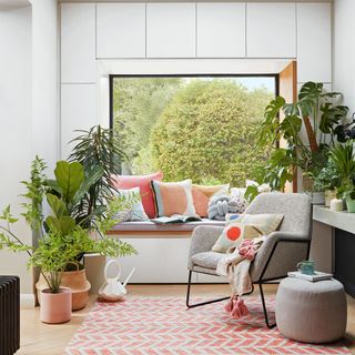 White room with large picture window and houseplants