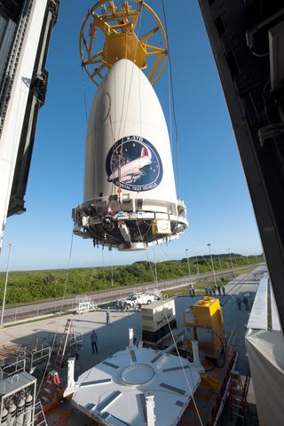 Encapsulated in its fairing, the United States Air Force's X-37B space plane is positioned for attachment to its Atlas V booster.