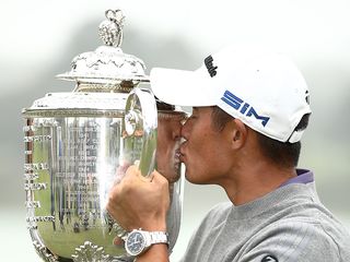 Collin Morikawa kissing the Wanamaker Trophy after winning the PGA Championship in 2020