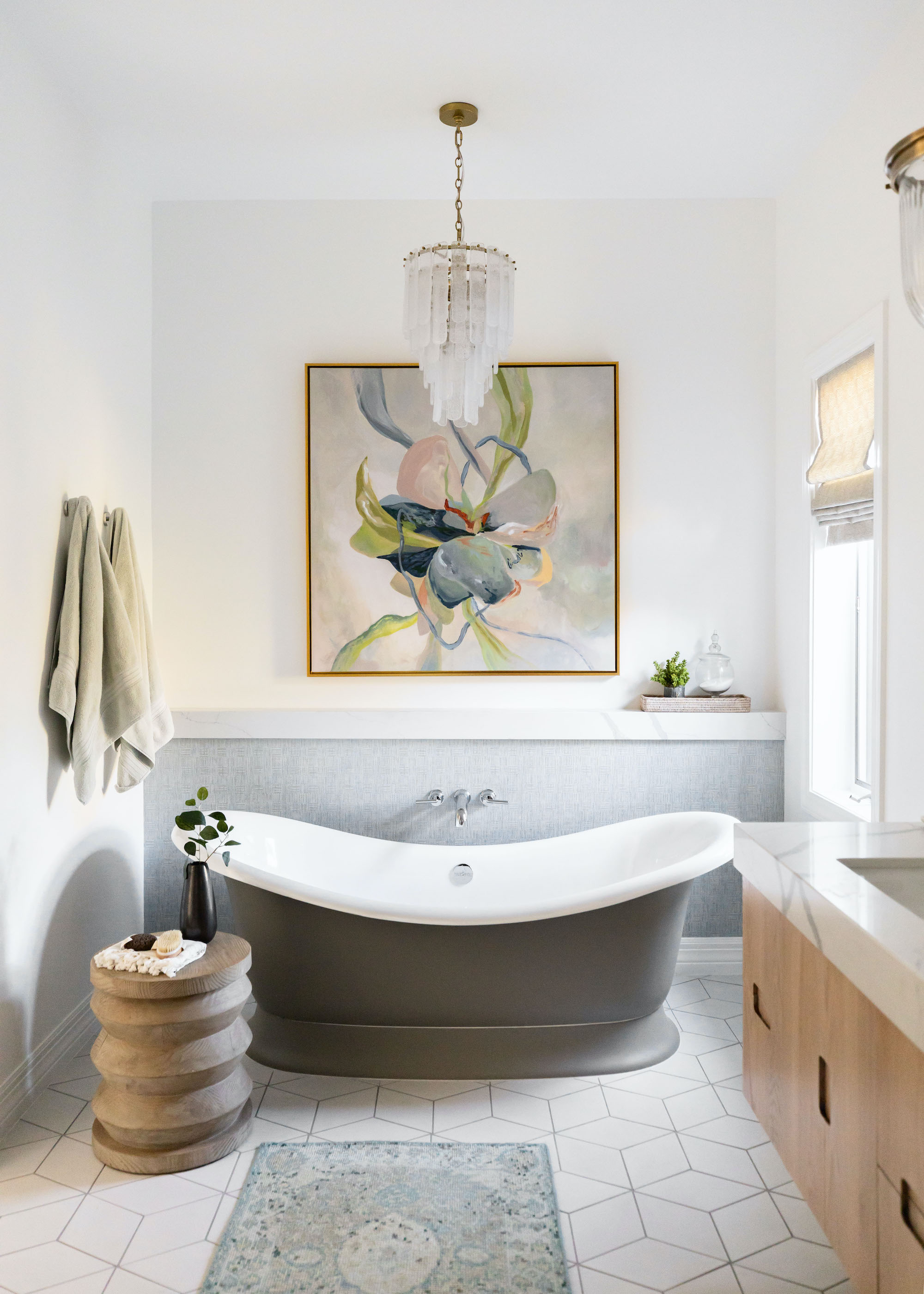 bathroom with bateau bath and large framed print above