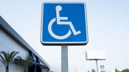 A disabled parking sign located in a shopping mall