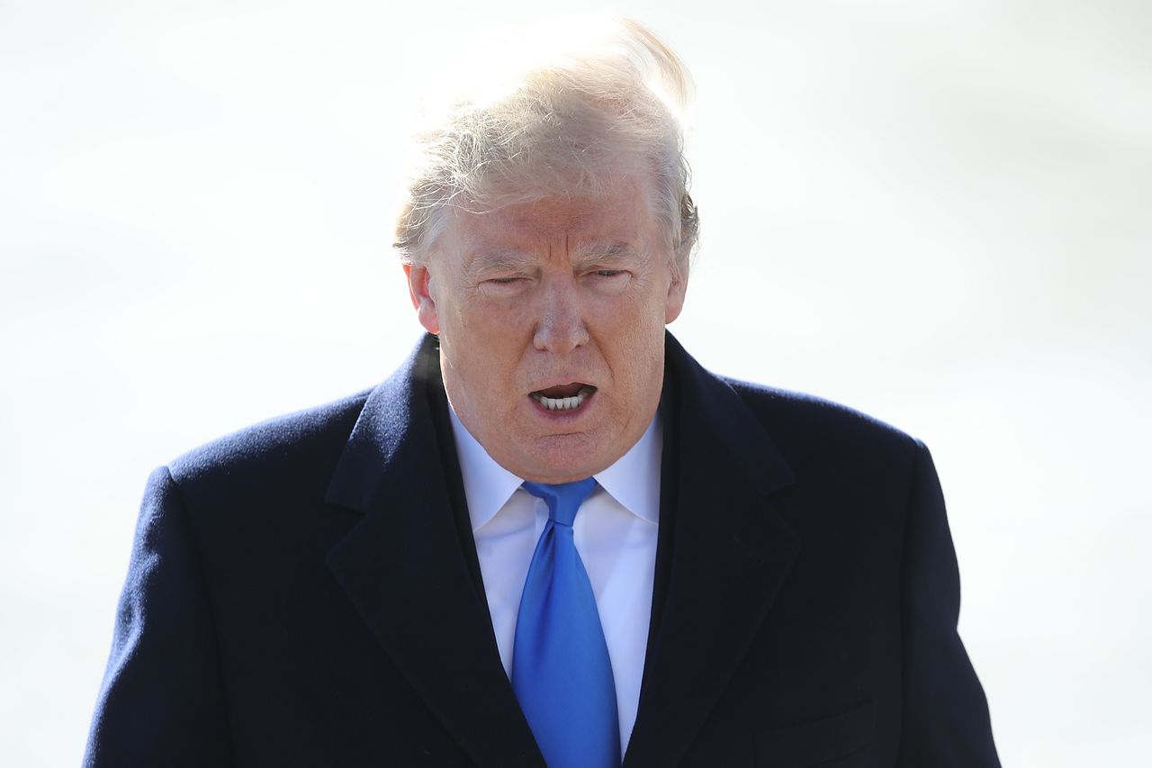 Trump walks from the Oval Office to a press conference