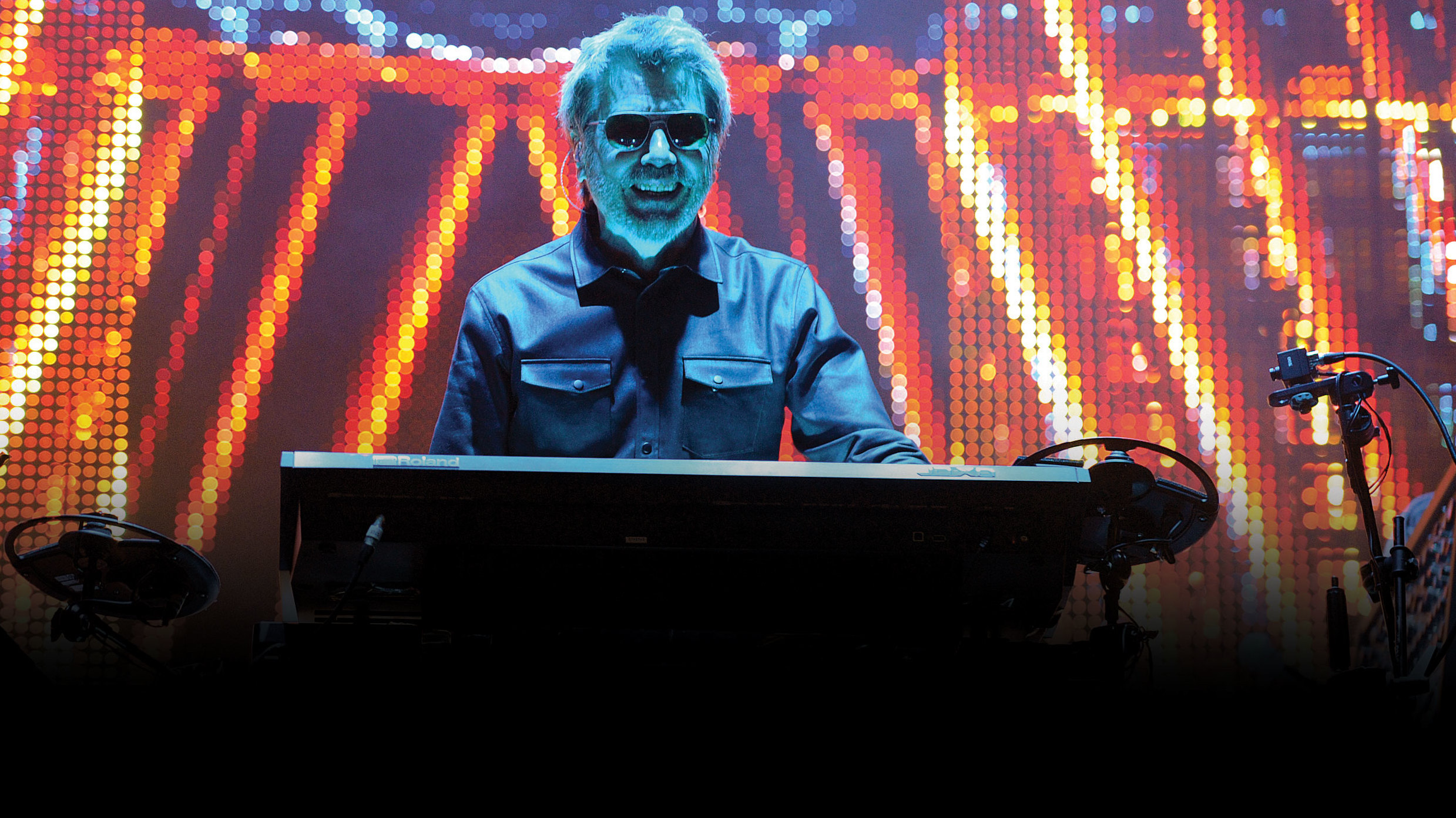 Jean-Michel Jarre against a screen of lights at Bluedot festival