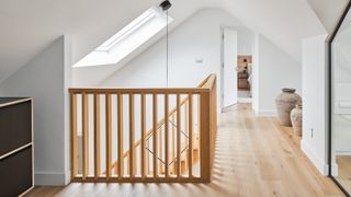 wooden loft conversion stairs leading to loft landing off which various rooms can be seen