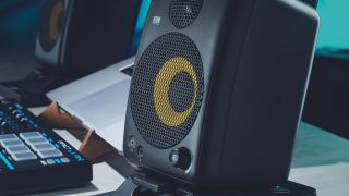 A pair of KRK GoAux studio monitors on a studio desk