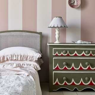 Handpainted bedside table in pink stripy bedroom