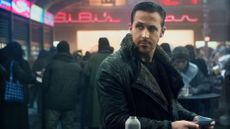 A shot of Ryan Gosling's K standing in a cyberpunk-like mall in Blade Runner 2049