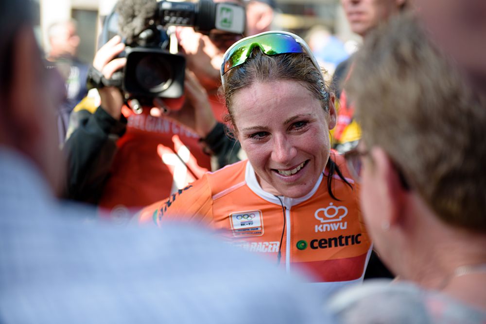 Annemiek van Vleuten celebrates the win with family whilst media swarm around the Dutch star at the 97 km Stage 3 of the Lotto Belgium Tour 2016