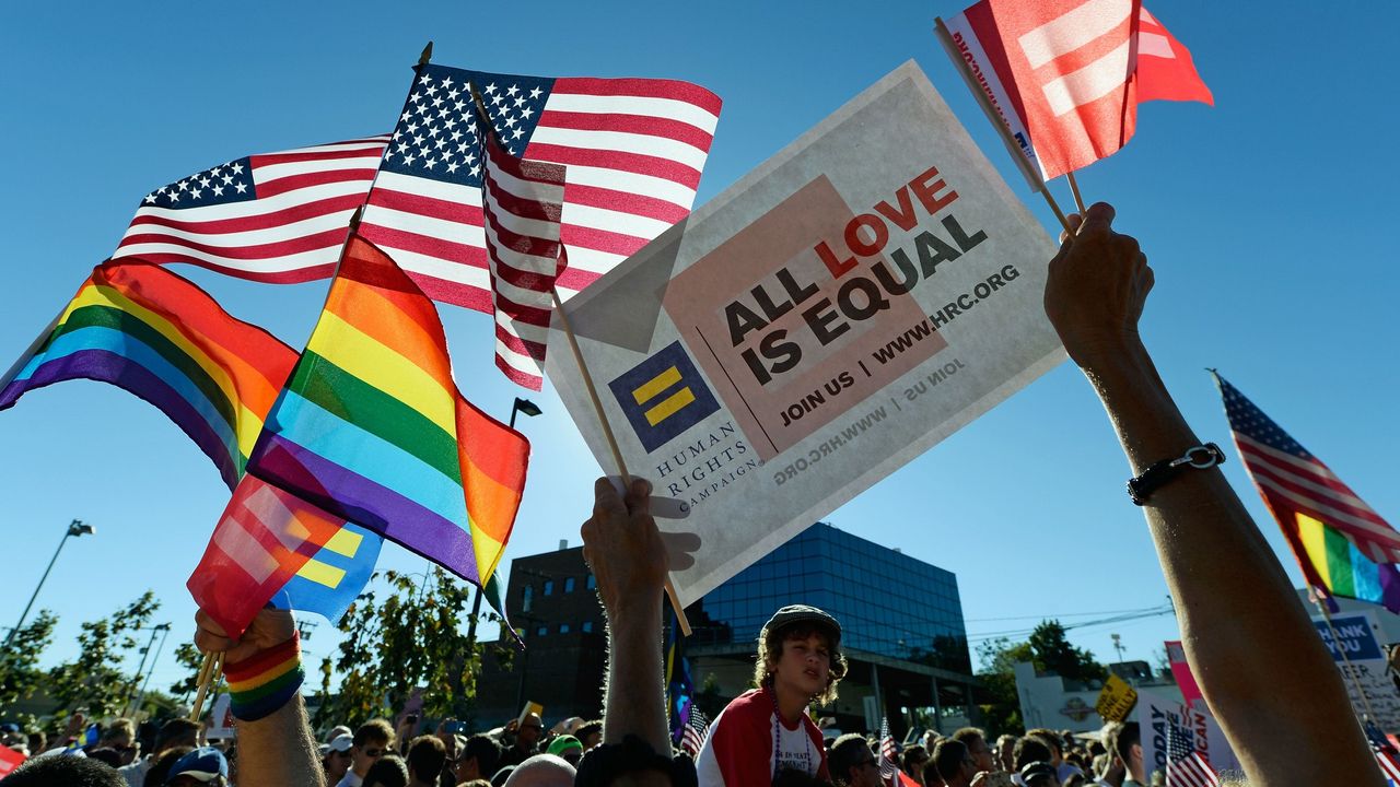 &quot;All Love is Equal&quot; - People gathered in support of Gay marriage holding USA &amp; Rainbow-colored LGBTQ flags