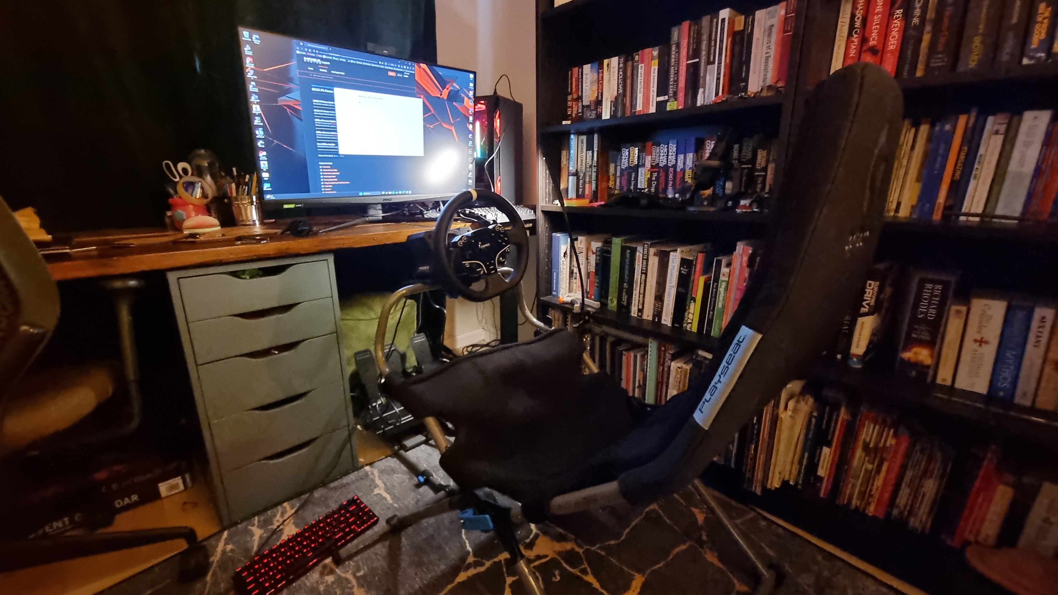 The Moza R5 bundle in full sim rig setup, attached to a Logitech Playseat Challenge X