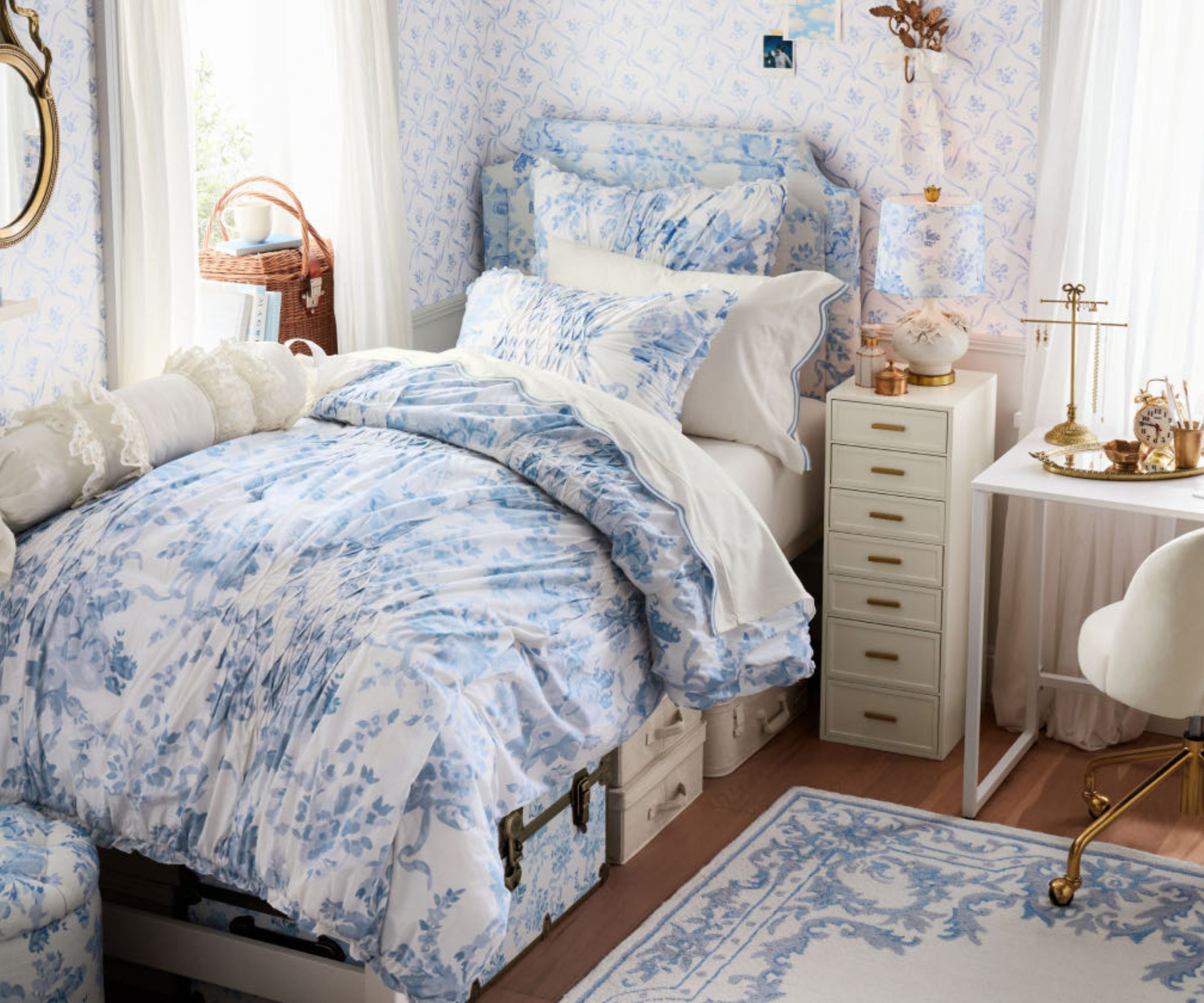 Single bedroom with patterned blue and white bedding, matching rug and headboard