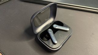 EarFun Air Pro 4 earbuds in their case on a mousepad