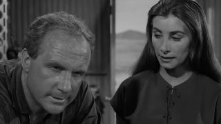 A woman looking at a stressed out man in The Lonely in The Twilight Zone