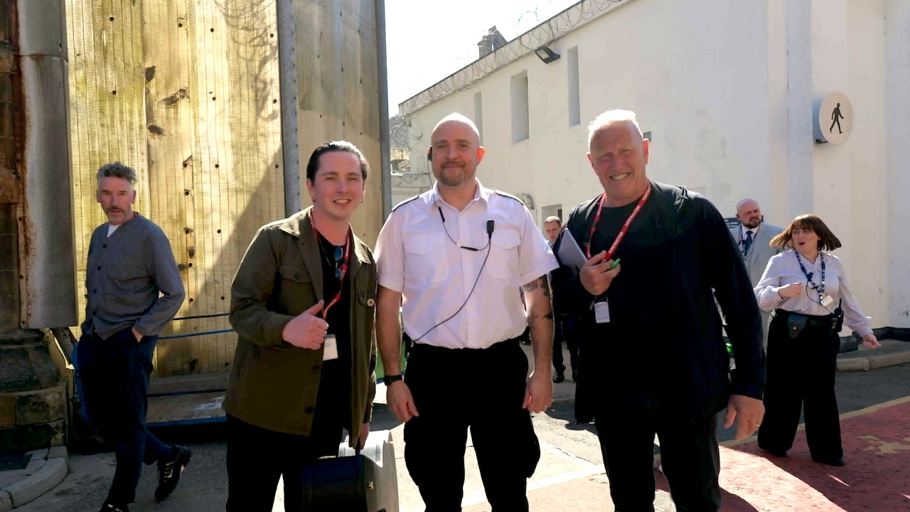Connor Whyte and Richard Jobson of the Skids with Residential Officer David Poliri at HMP Barlinnie