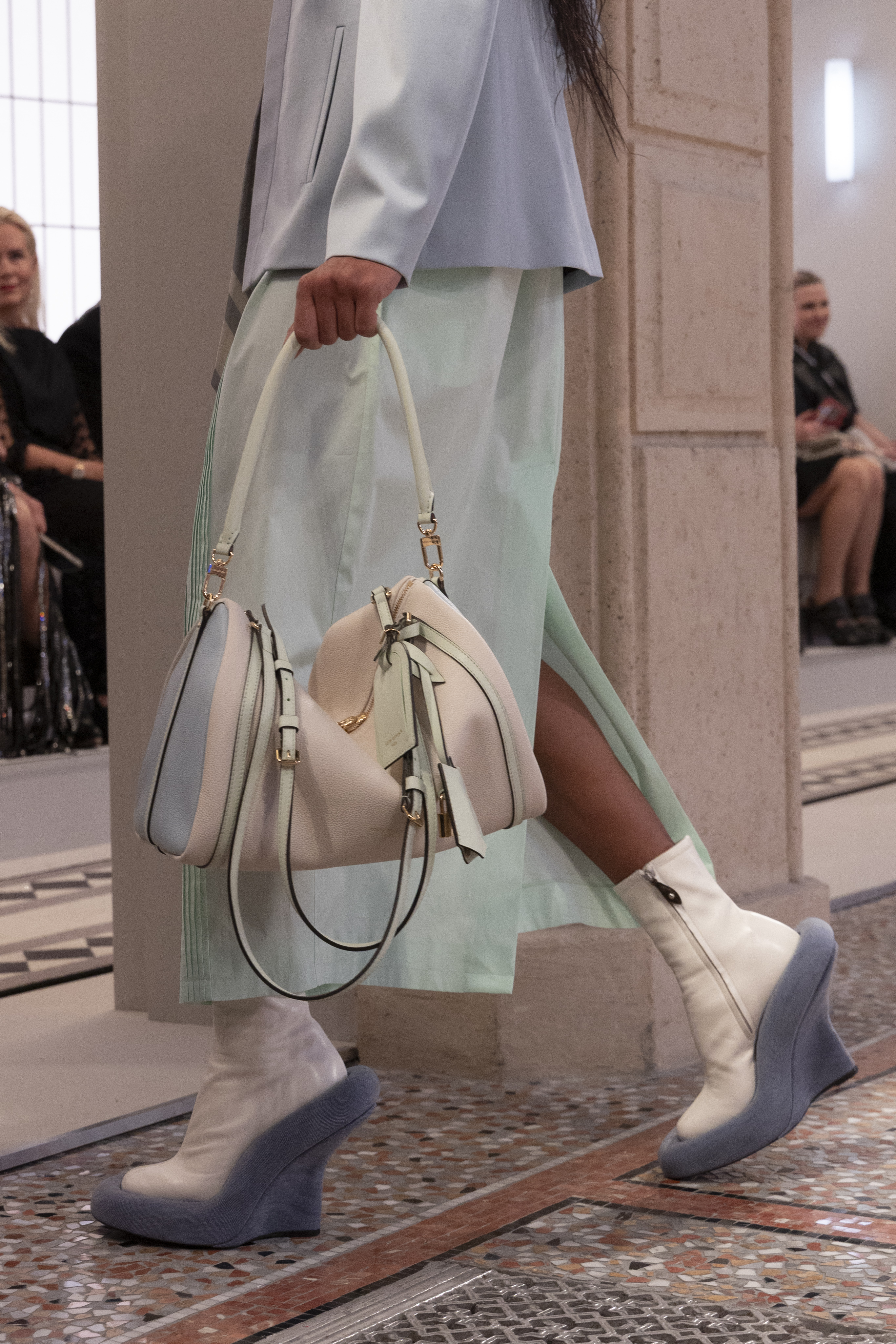Model on the runway carrying the Louis Vuitton Express bag.