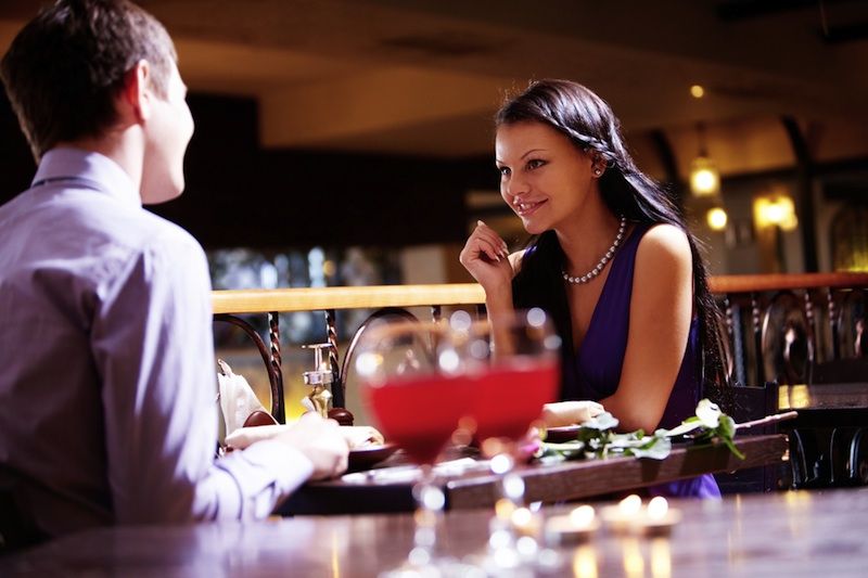 A young couple on a date at a restaurant.