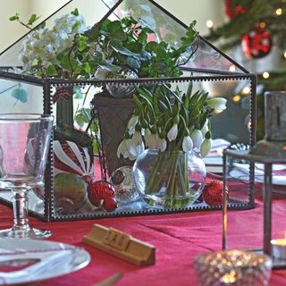 christmas dining table with centrepiece and red. tablecloth