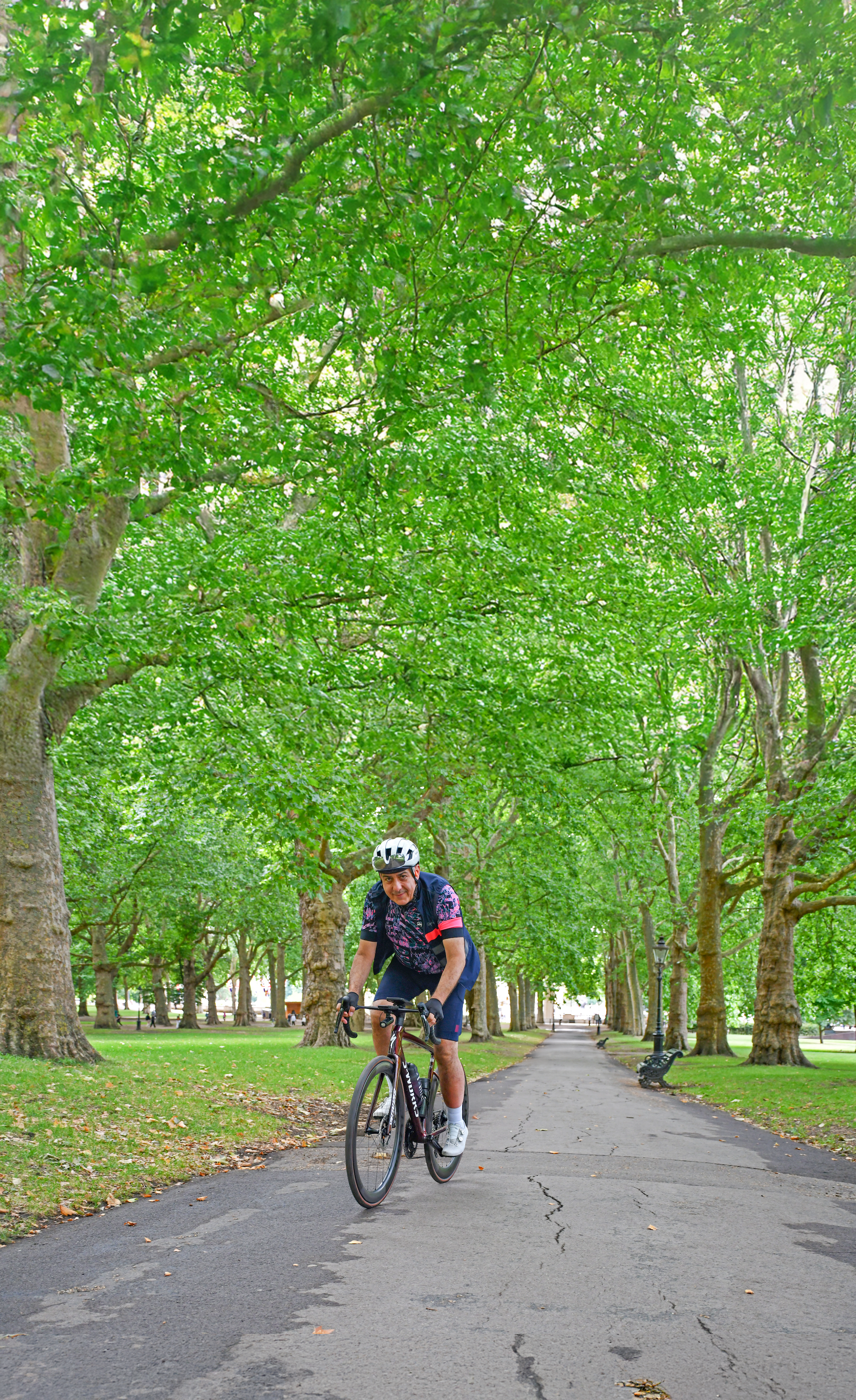 Nicolas Georgiou cycles through a park