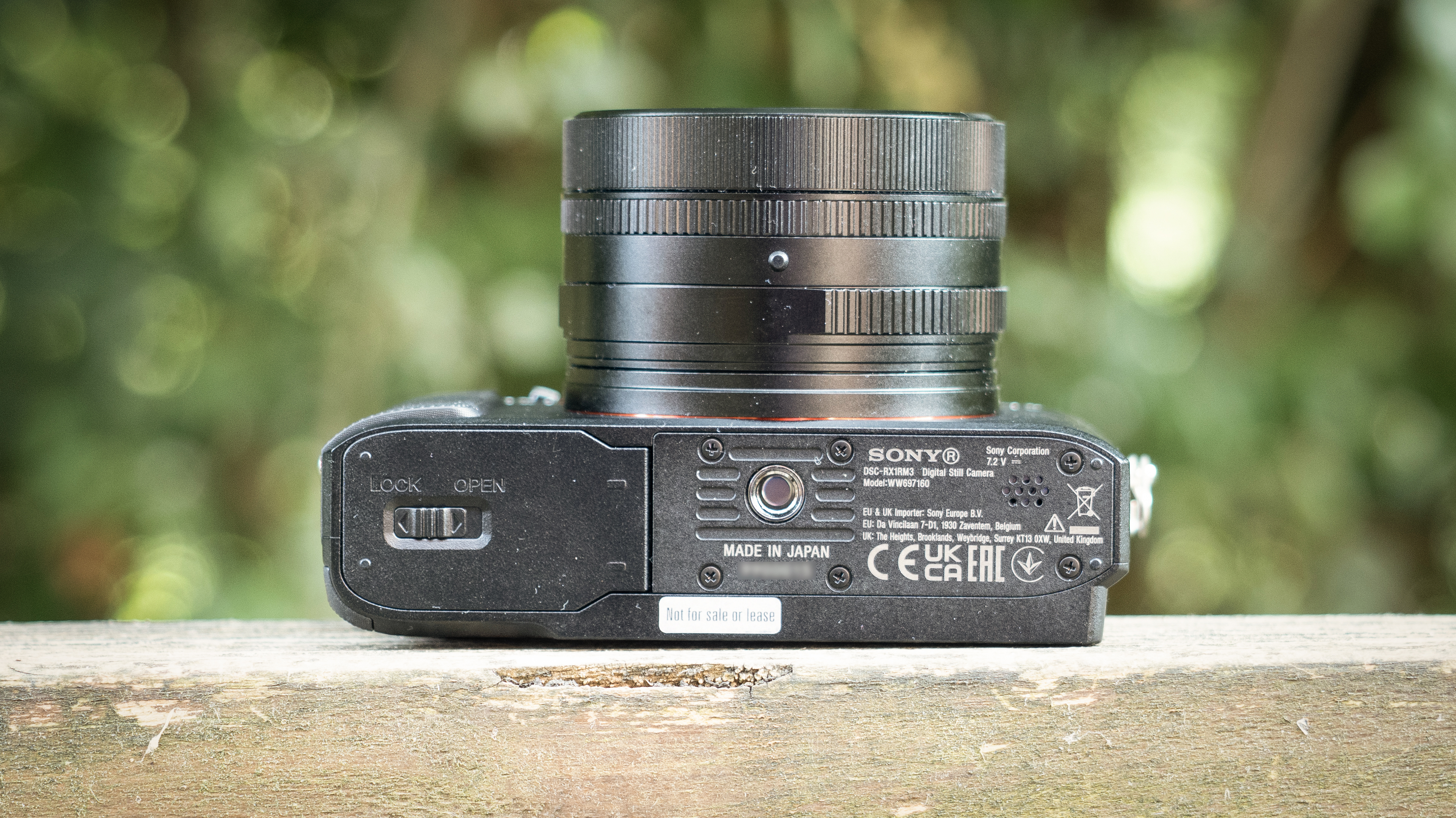 Sony RX1R III on a wooden surface in a woodland environment
