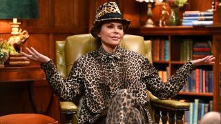 Lisa Rinna in cheetah ensemble shrugging. 