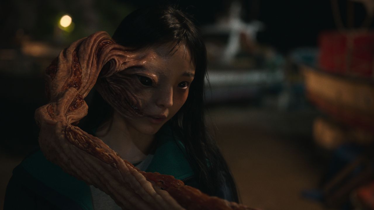 a woman (Jeon So-nee as Jeong Su-in) with a deformed tentacle protruding from half of her face, in &#039;parasyte the grey&#039;