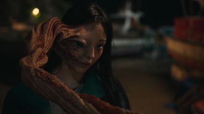 a woman (Jeon So-nee as Jeong Su-in) with a deformed tentacle protruding from half of her face, in 'parasyte the grey'